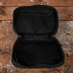 GORUCK black FIELD pocket organizer with mesh zippered compartments on rustic wood