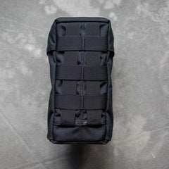GORUCK black tactical water bottle pouch with MOLLE webbing on grey surface