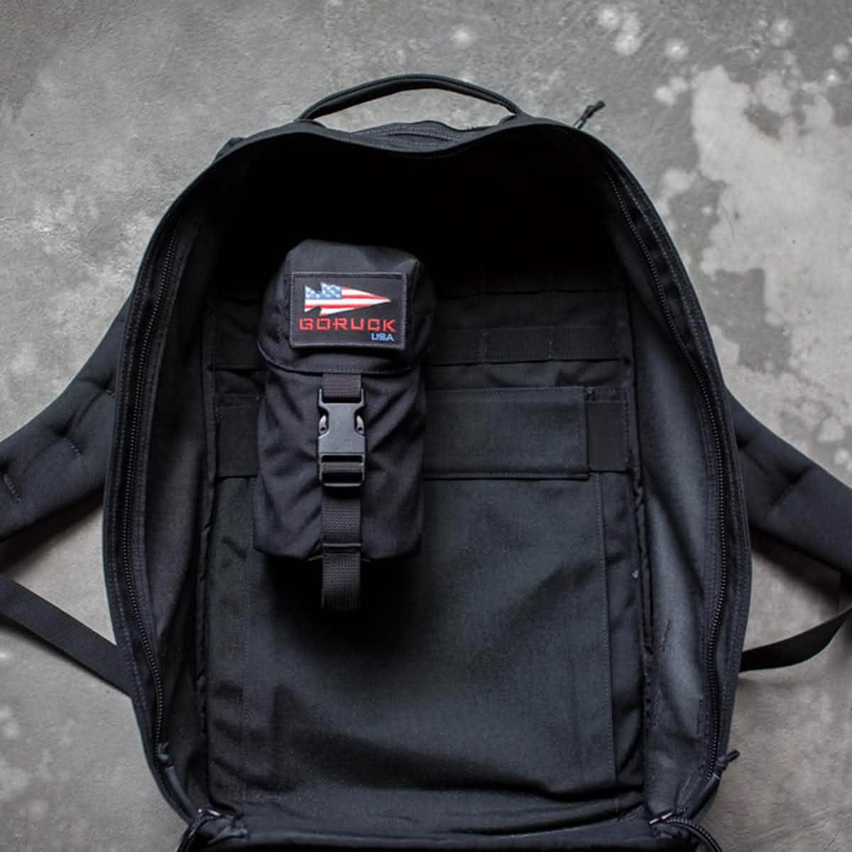 GORUCK backpack open with full panel water bottle pocket inside, rucking gear storage