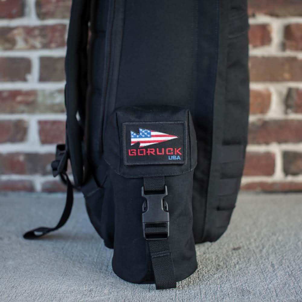 GORUCK black rucksack side with full-panel water bottle pocket and GORUCK USA patch