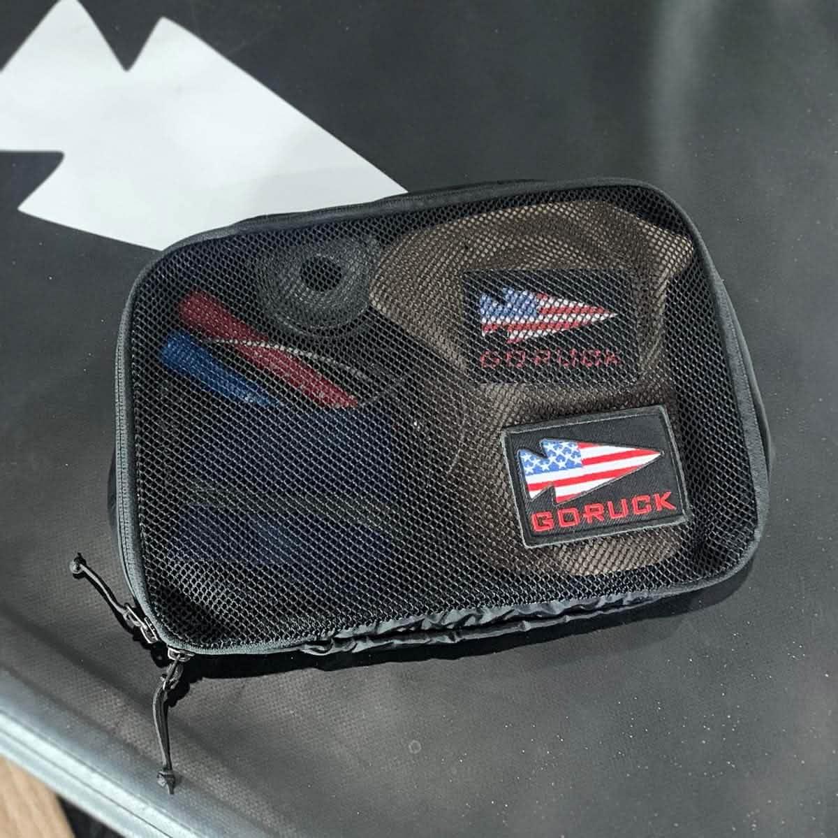 GORUCK 5L packing cube with mesh top, visible gear and American flag patches