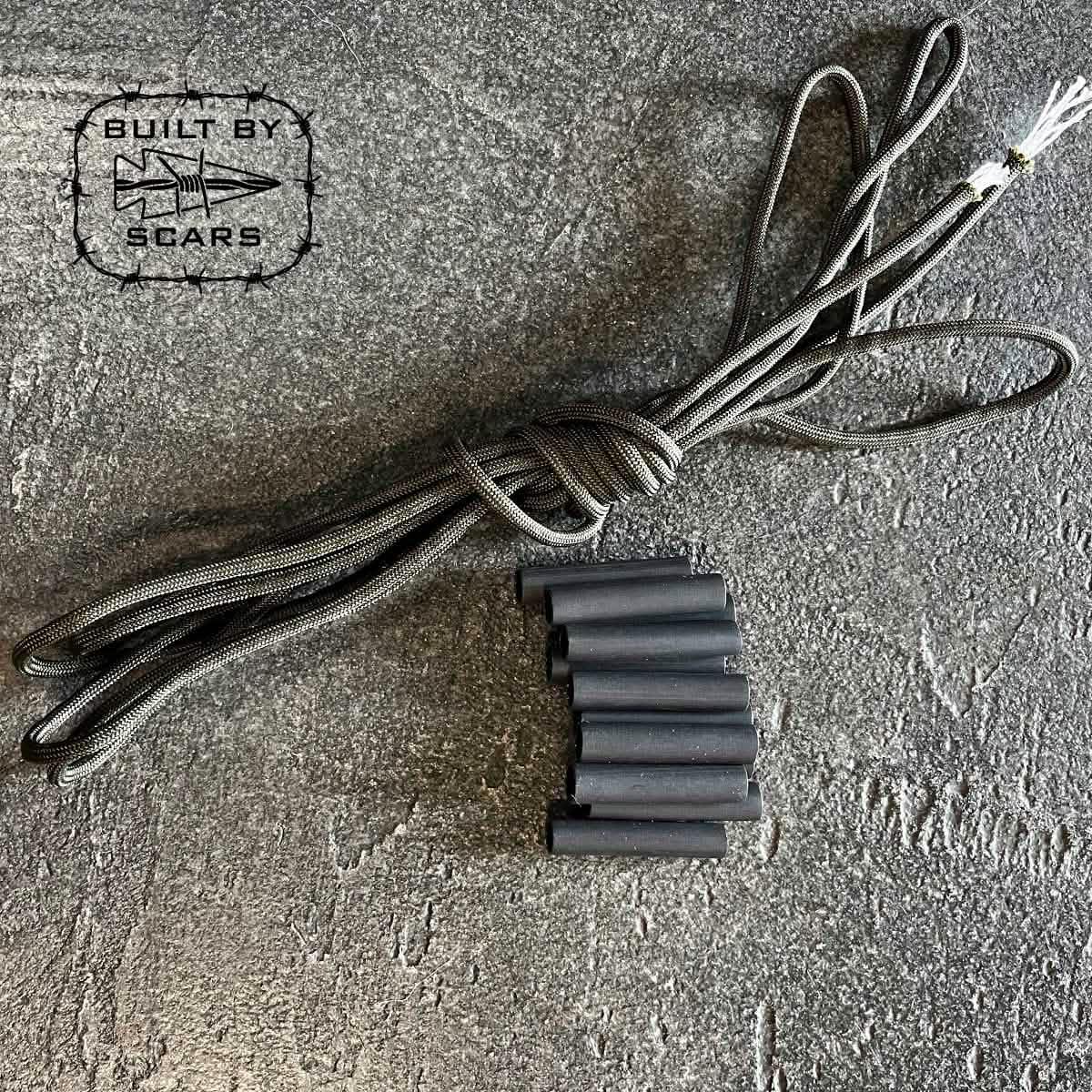 GORUCK paracord and heat shrink tubing kit on textured gray surface, Built by Scars logo