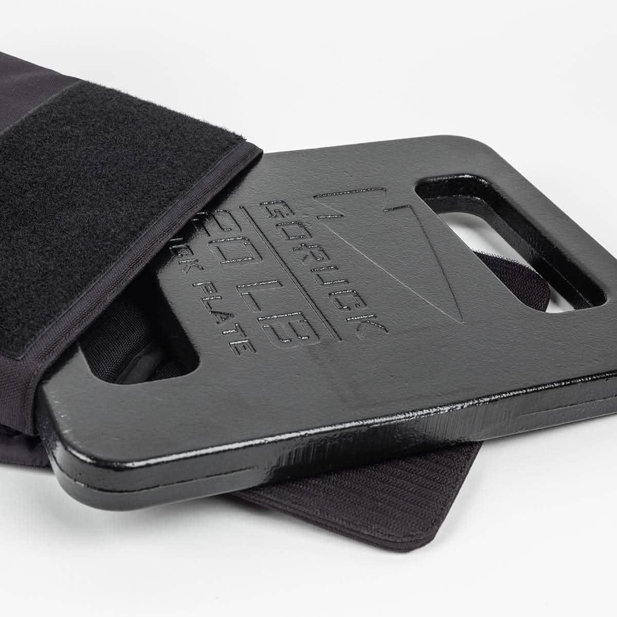 GORUCK 20LB ruck plate in black partially inserted into a rucksack pocket on white background