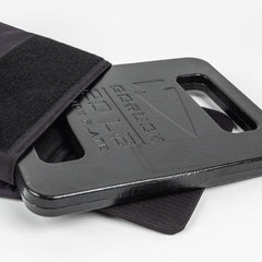GORUCK 20LB ruck plate in black partially inserted into a rucksack pocket on white background