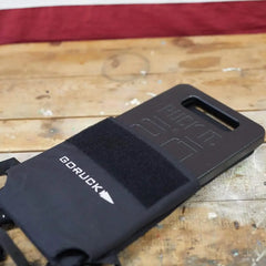 GORUCK 20LB ruck plate weight on wooden table with branded sleeve, fitness gear