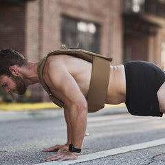 Man doing push-ups outdoors in GORUCK Ranger Panties shorts and a weighted training vest
