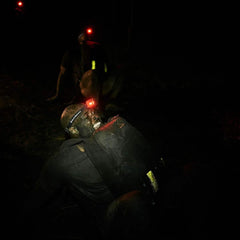 GORUCK rucker with reflective bands and headlamp participating in night rucking event
