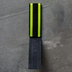 GORUCK reflective ruck band with velcro, black and neon yellow, on concrete surface