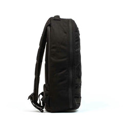 GORUCK black rucksack side view, rugged tactical backpack with padded straps, isolated on white