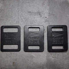 GORUCK ruck plates 10lb, 20lb, and 30lb weights on concrete floor