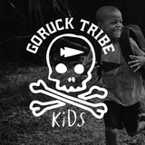 Smiling child in GORUCK Tribe Kids t-shirt running outdoors with backpack, GORUCK logo overlay