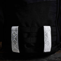GORUCK black ruck sack with two white reflective MOLLE straps for rucking gear