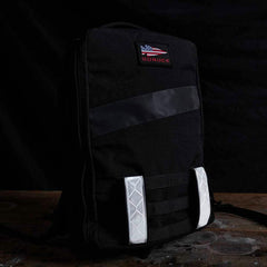 GORUCK black rucksack with reflective strips and American flag patch on dark background